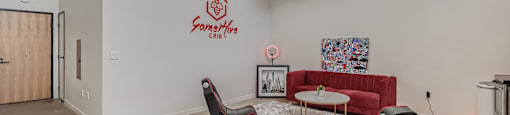 A room with a white wall and a red couch.