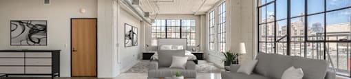 A modern living room with a grey sofa and a wooden coffee table.