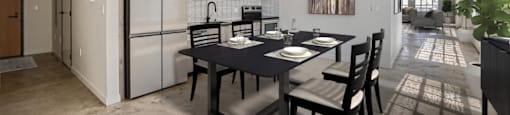 A dining room with a table set for two and a kitchen area with a refrigerator and a sink.