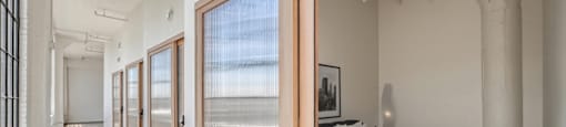 A bedroom with a bed, a window, and a door.