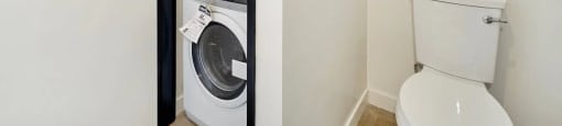 A white toilet sits next to a white washing machine in a small room.