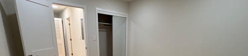 A room with a wooden floor and white walls.