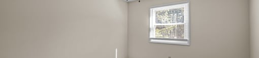 an empty room with a ceiling fan and a window at Raleigh Rentals, Raleigh, NC