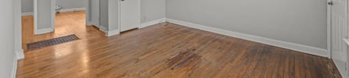 A room with wooden floors and white walls. at Raleigh Rentals, North Carolina, 27604