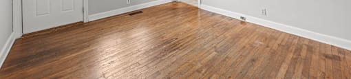 A room with a wooden floor and white walls. at Raleigh Rentals, North Carolina, 27604