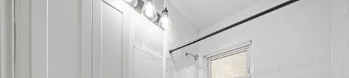 A white bathroom with a tub, sink, and toilet. at Raleigh Rentals, North Carolina, 27604
