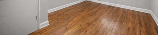 A room with a ceiling fan and wooden flooring. at Raleigh Rentals, North Carolina, 27604