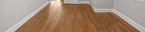 A room with a ceiling fan and wooden floors. at Raleigh Rentals, North Carolina, 27604