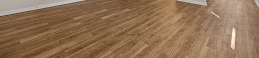 the living room and dining room of an apartment with wood flooring at Raleigh Rentals, North Carolina, 27604