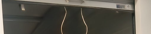 A metal shelving unit with a wire hanging from the top.