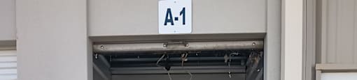 A white door with a sign above it that says A-1.