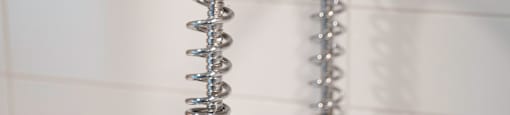 A chrome shower head with a hose attached to it.
