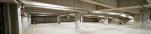 A parking garage with yellow lines on the ground.
