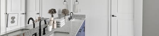 A kitchen with a sink and a towel on the floor.