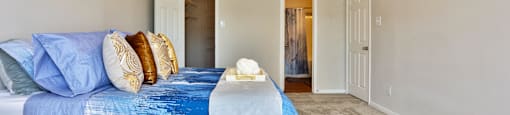 A1 bedroom with a bed, closet, and a ceiling fan at The Inverness Apartments in Houston, TX
