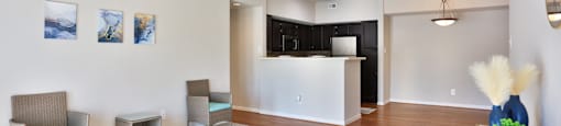 A1 living room with a ceiling fan and a grey carpet at The Inverness Apartments in Houston, TX