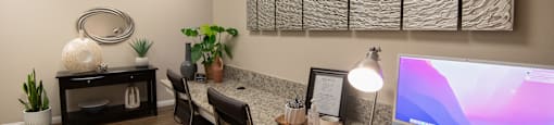 A modern office with a wooden desk and a computer monitor.