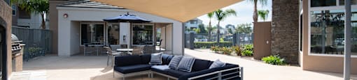 A modern outdoor seating area with a curved wooden roof.