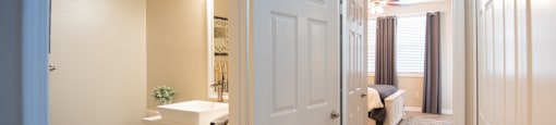 A bathroom with a toilet, sink, and mirror is shown.
