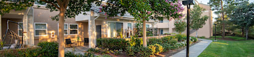 A residential area with apartment buildings and a sidewalk.
