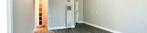 A room with a grey floor and white walls.