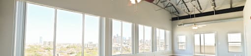 an open penthouse living room with large windows
