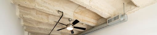 A room with wooden floors and a ceiling fan.