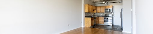A room with wooden floors and a ceiling fan.