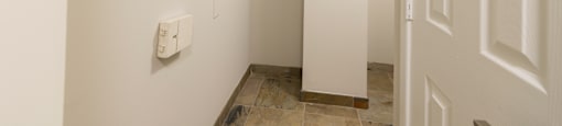 A white door is on the right side of a hallway.