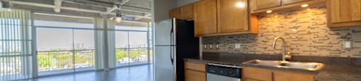 A kitchen with wooden cabinets and a black countertop.