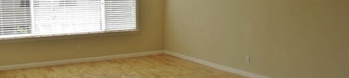 Living Room Picture Window and Wood Finish Flooring