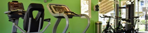 community fitness center with stationary bikes, treadmill, and weight machines