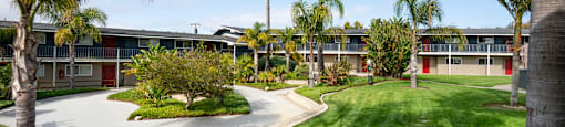 a building with palm trees in the background