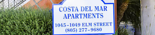 Sign for Costa Del Mar apartments on stairwell