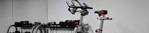 View of community gym spin bike and free weights in the background