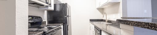 a kitchen with stainless steel appliances and white cabinets