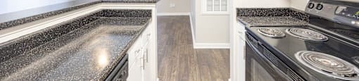 a kitchen with granite counter tops and stainless steel appliances
