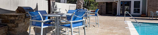 a patio with chairs and tables and a swimming pool