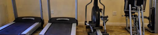 community fitness center with treadmill, stationary bike, and elliptical