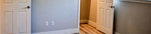 bedroom with wood look flooring and large window