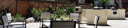 View of grilling area in pool area and seating areas throughout