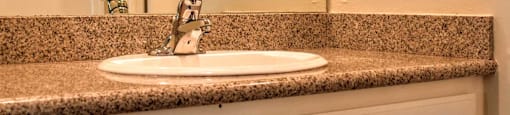 bathroom vanity view with large mirror, lighting, and medicine cabinet