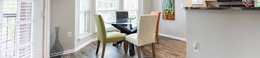 a dining room with a table and chairs and a window