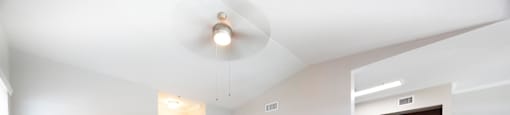 the living room and kitchen of an empty apartment with wood flooring