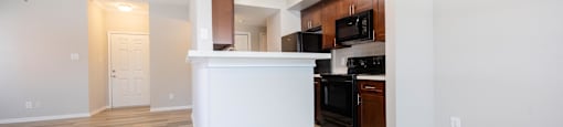 a kitchen and living room with a white counter top and