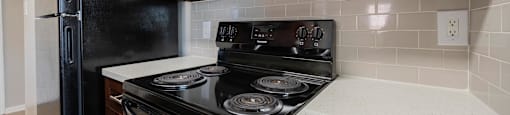 a kitchen with a stove and microwave and a refrigerator