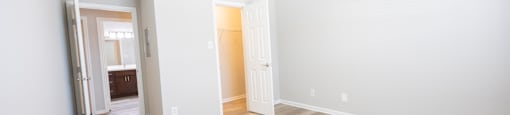 a room with a hard wood floor and white walls