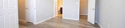 a renovated living room with white walls and wood floors