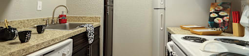 A view of the kitchen, with dark wood cupboard and new appliances