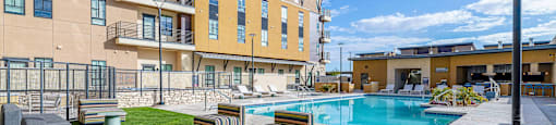 Swimming Pool And Relaxing Area with lounge chairs at Solace at Ballpark Village, Goodyear, Arizona
